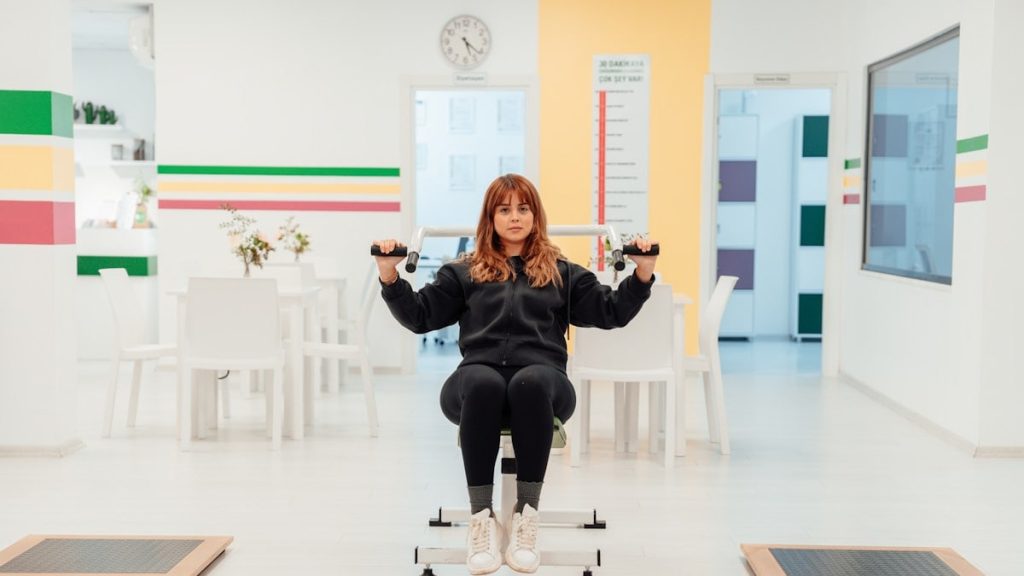 a woman sitting on top of a machine in a room