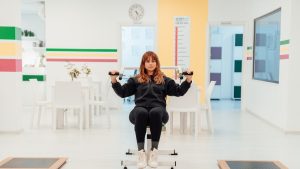 a woman sitting on top of a machine in a room